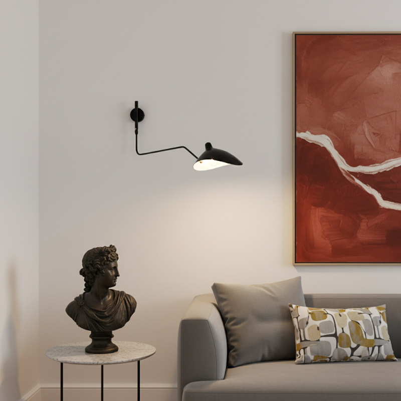 Arclume wall lamp near a sofa and artwork