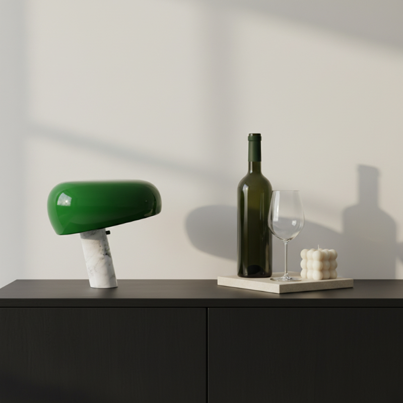 Green Slantia table lamp beside bottles and glassware