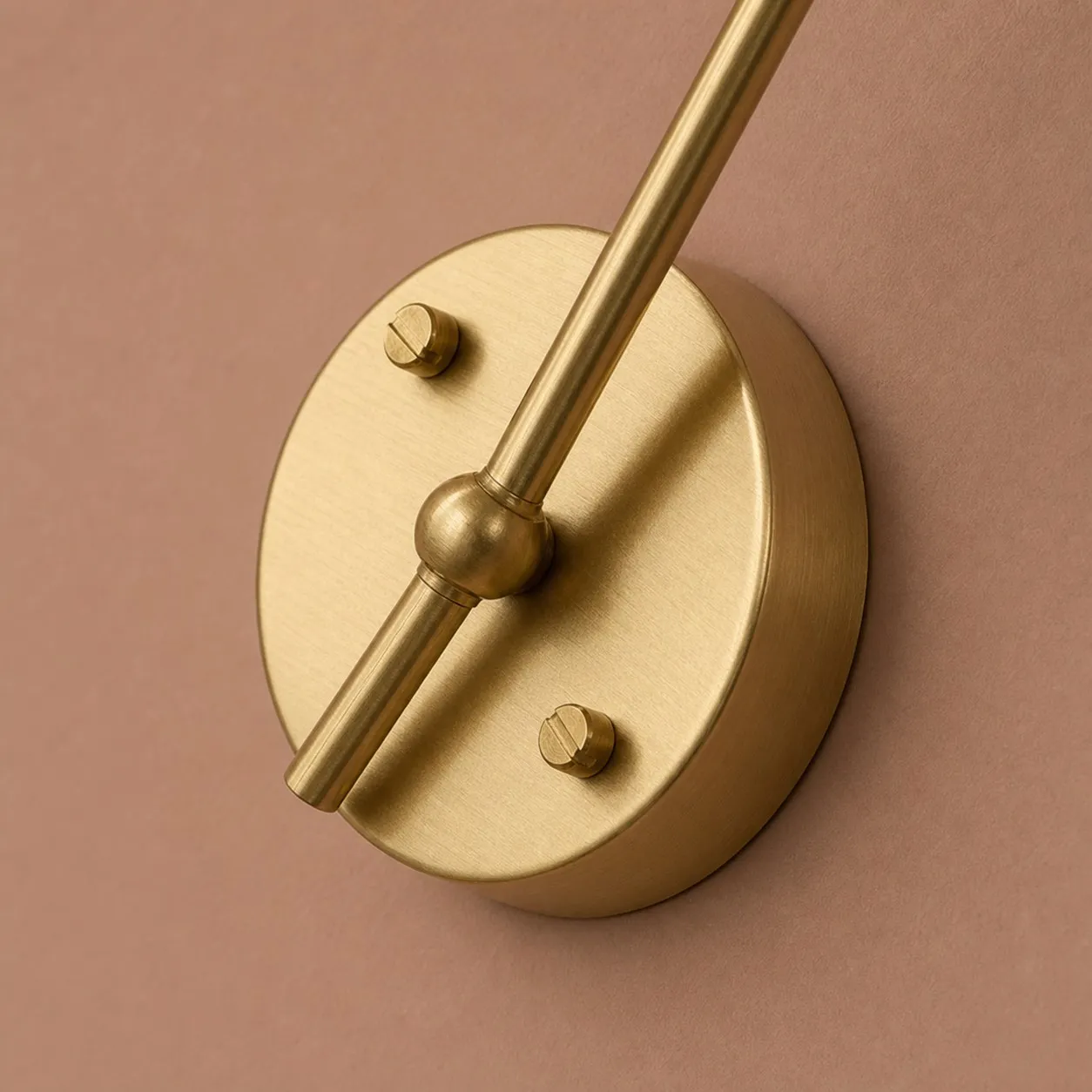 Round brass wall backplate detail on glass wall light