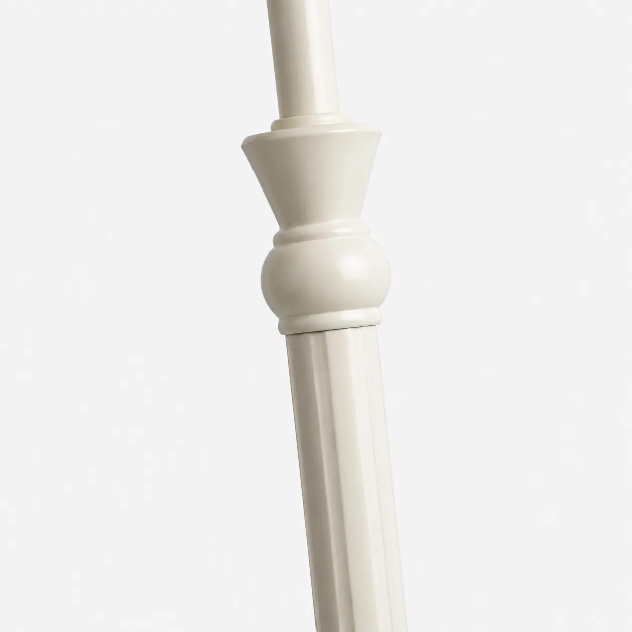 Close-up of turned decorative details on the ivory metal lamp stem